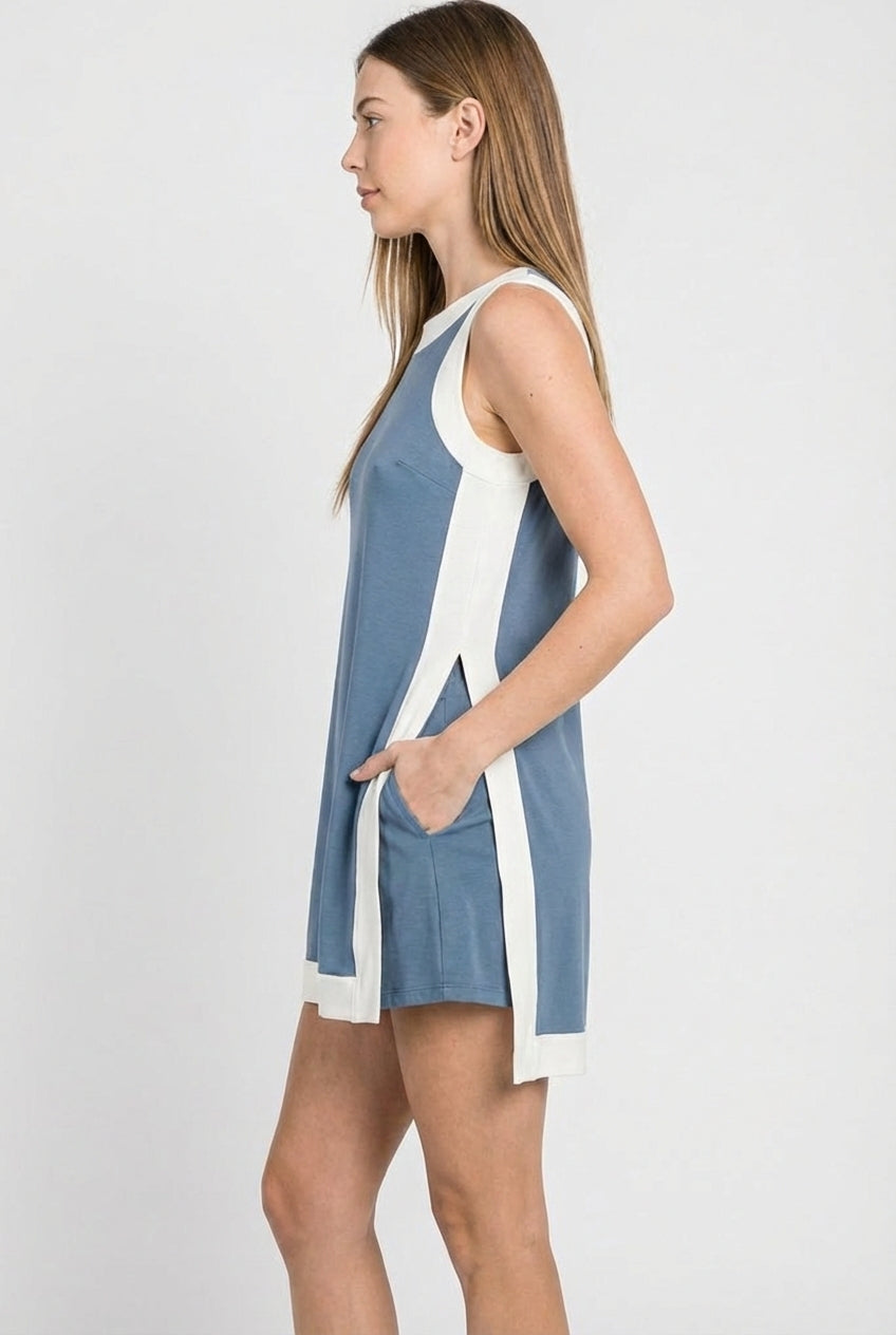 Blue sleeveless tunic dress from side view with white trim and long back hem slit