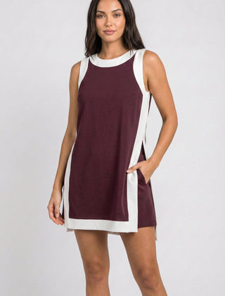 Maroon sleeveless dress with white trim, side slits, and crew neckline