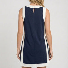 Back view of sleeveless navy game day dress with vertical white side panels
