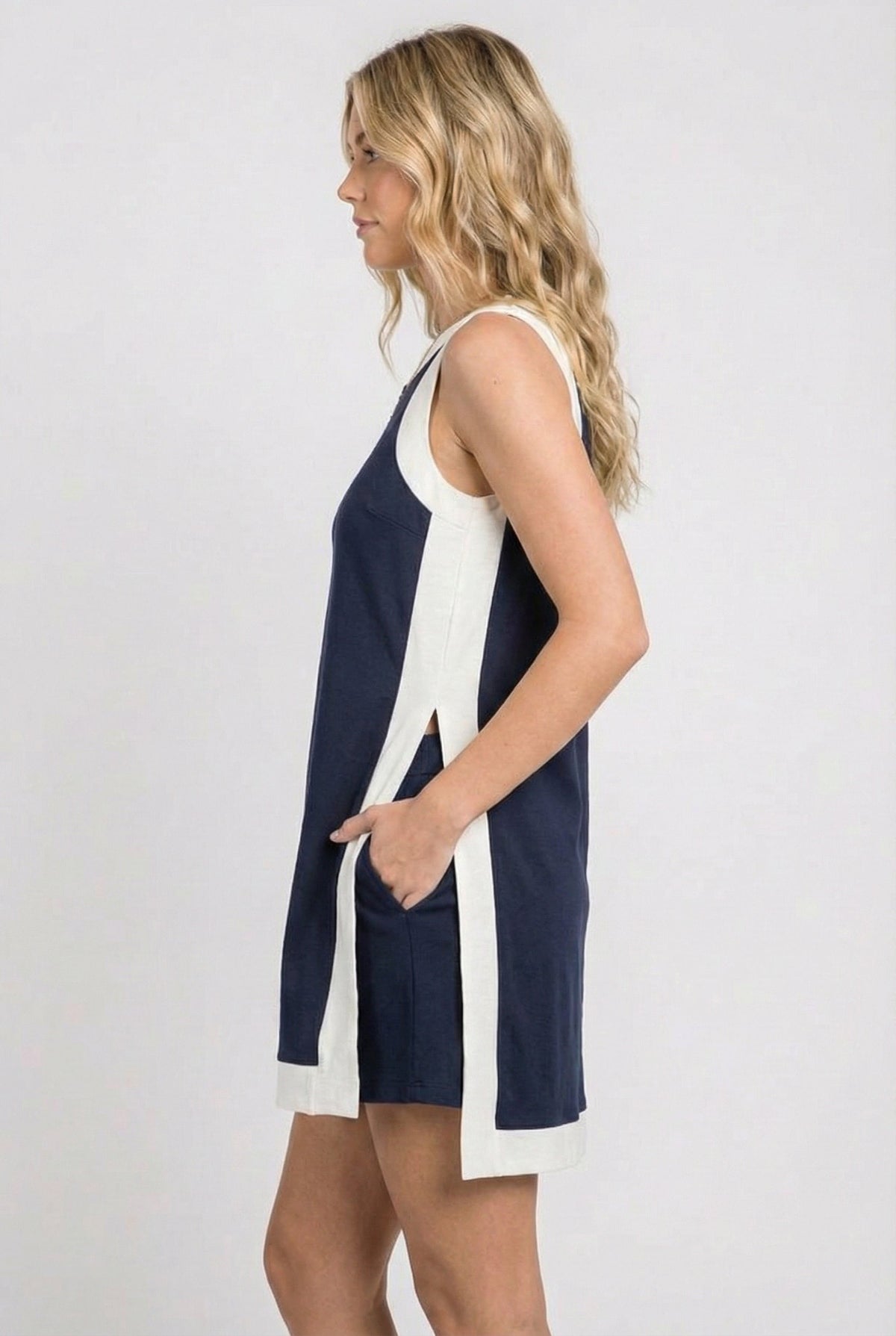 Sleeveless navy game day dress with white side panels and side slit detail