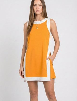Orange sleeveless tunic dress with white crew neck, hem border, and side tie ribbon
