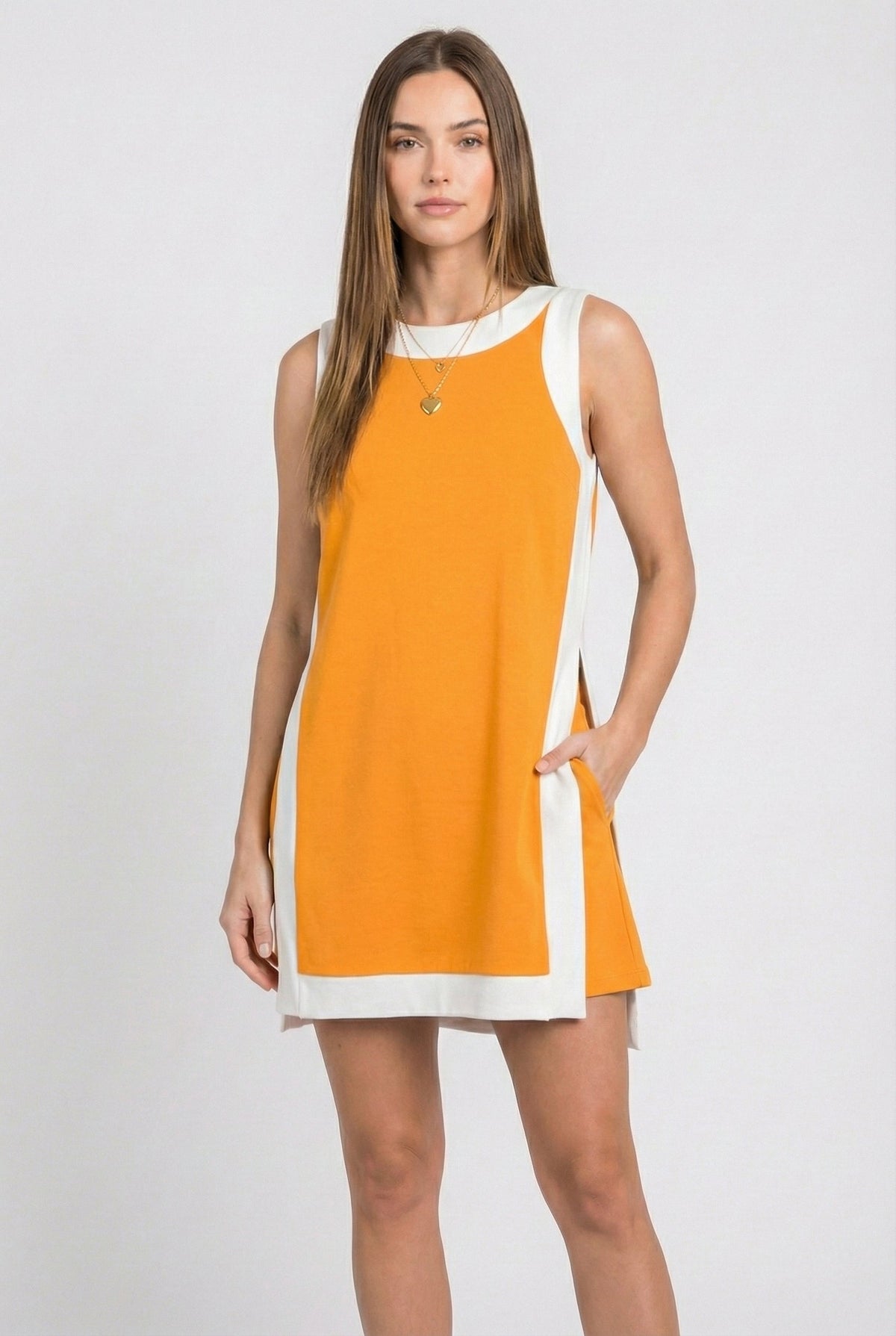 Orange sleeveless tunic dress with white crew neck, hem border, and side tie ribbon