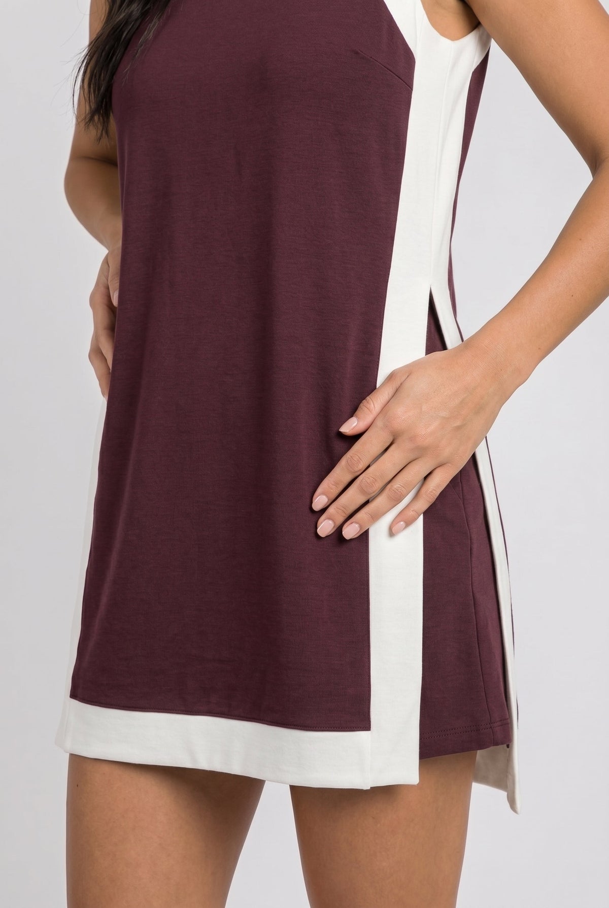 Maroon sleeveless dress with white hem trim and side panel detail