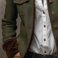 Olive herringbone jacket sleeve and chest pocket with gold-tone buttons over white blouse