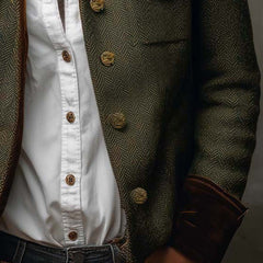 Olive herringbone jacket with gold-tone button rows and flap pocket near hem