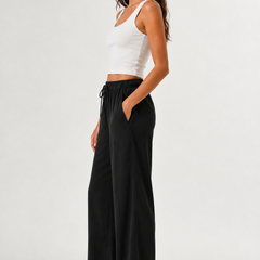 Brennan pants in black, side view wide-leg with elastic waistband and drawstring