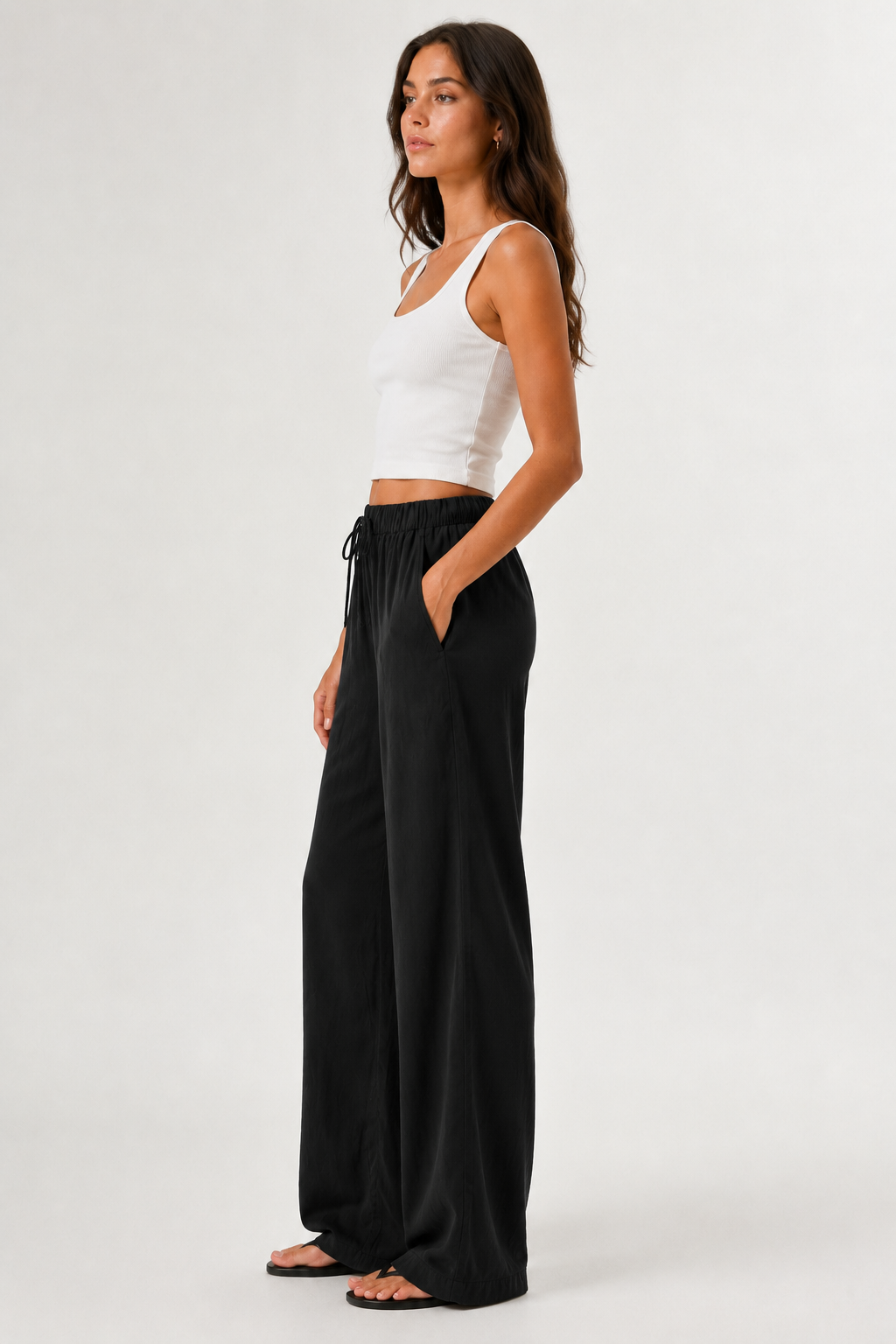 Brennan pants in black, side view wide-leg with elastic waistband and drawstring
