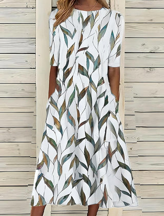 Coastal Bloom dress with white base and green-and-brown leaf print, short sleeves