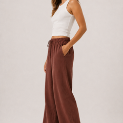 Spiced cognac wide-leg drawstring pants with gathered waist and full-length relaxed fit.