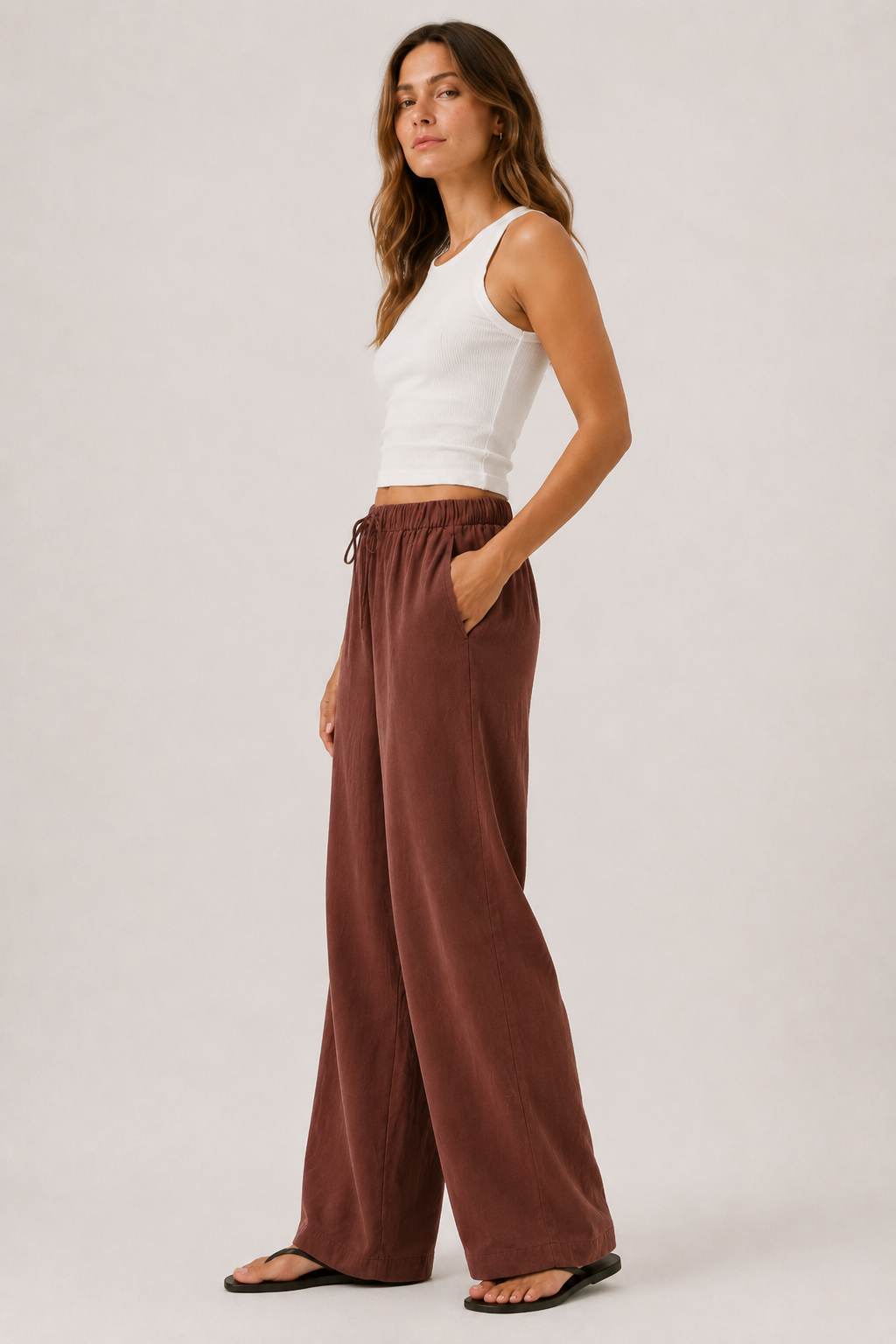 Spiced cognac wide-leg drawstring pants with gathered waist and full-length relaxed fit.