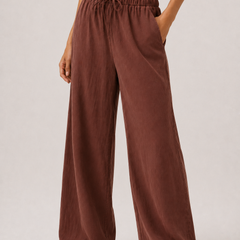 Spiced cognac wide-leg pants with elastic drawstring waist and long flowing legs.