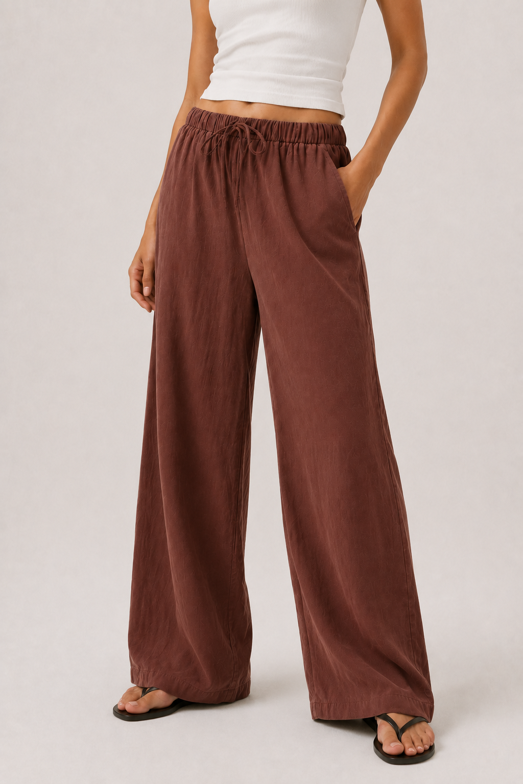 Spiced cognac wide-leg pants with elastic drawstring waist and long flowing legs.