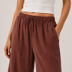 Spiced cognac wide-leg pants with elastic drawstring waist and subtle drape.