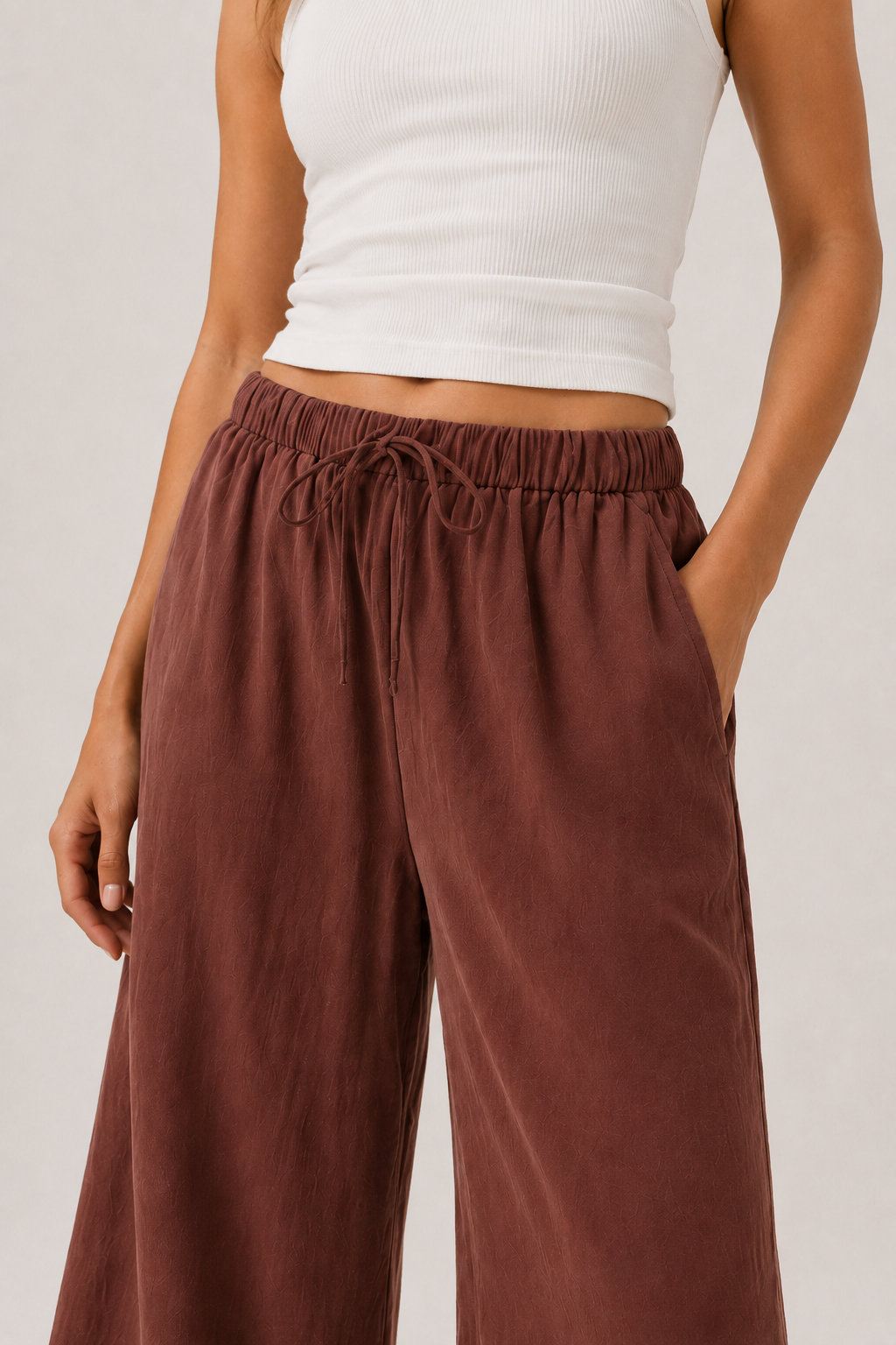 Spiced cognac wide-leg pants with elastic drawstring waist and subtle drape.