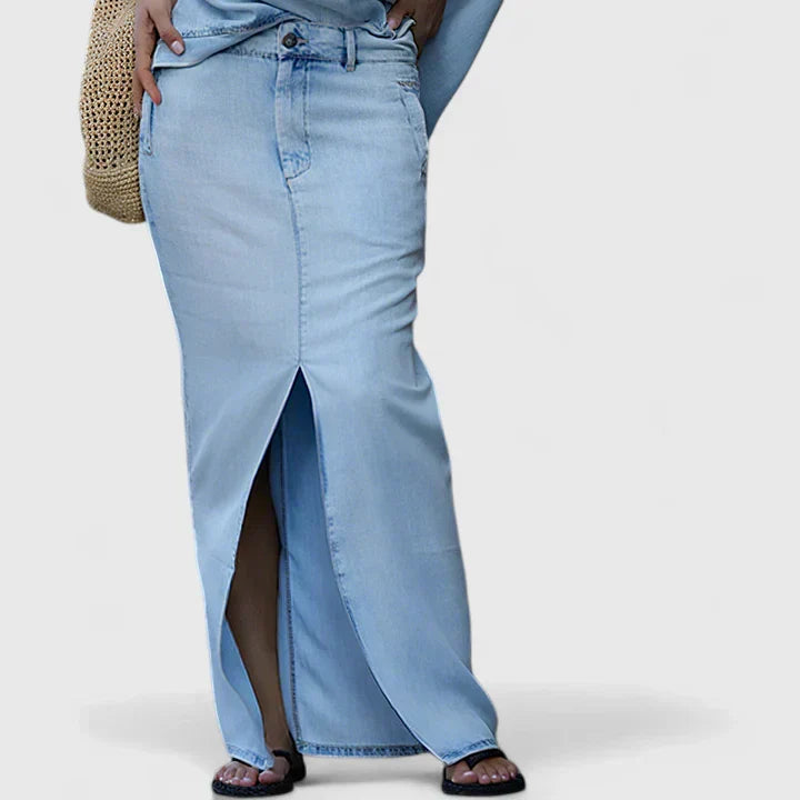 Blue denim maxi skirt with side slit, waist and top hem visible