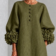Olive midi dress close-up: round neckline, vertical button row, rosette sleeve cuffs