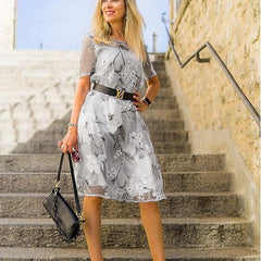 Gray floral midi dress with short sleeves and belted waist, flared skirt