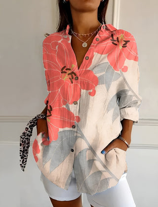 Coral and pink floral summer blouse with button front, collared V-neck, and rolled sleeves