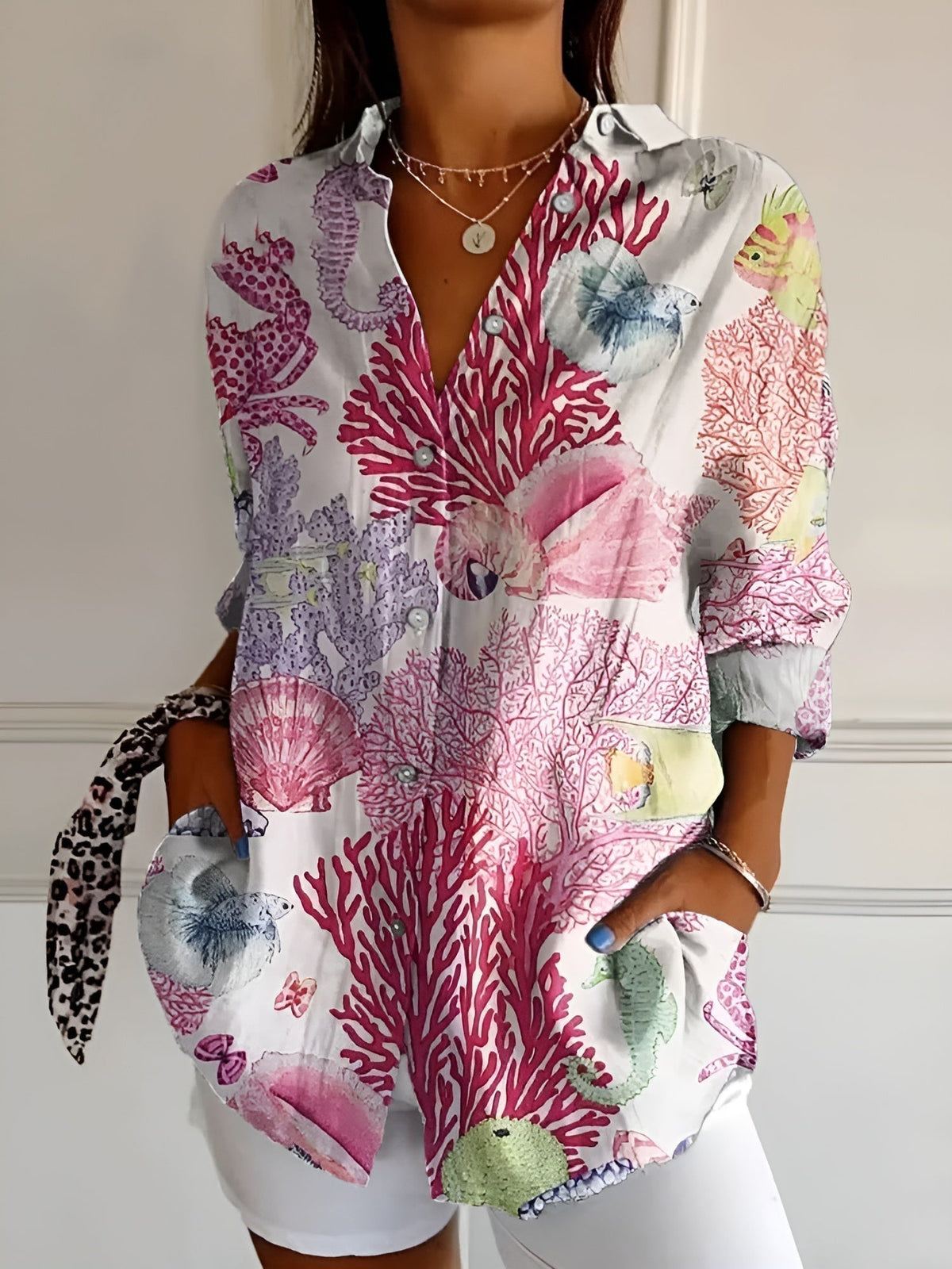 Pink and purple coral print summer blouse with button front, collared V-neck, rolled sleeves