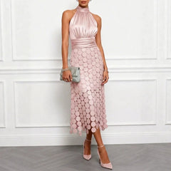 Pink halter neck midi dress with scalloped scale pattern and fitted drape at waist