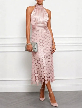 Pink halter neck midi dress with scalloped scale pattern and fitted drape at waist
